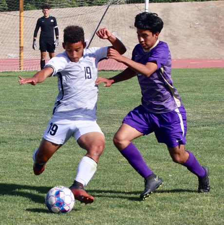 Lemoore's Jose Horta and Memorial's Christian Valdez battle for the ball during Thursday's CIV playoff game.